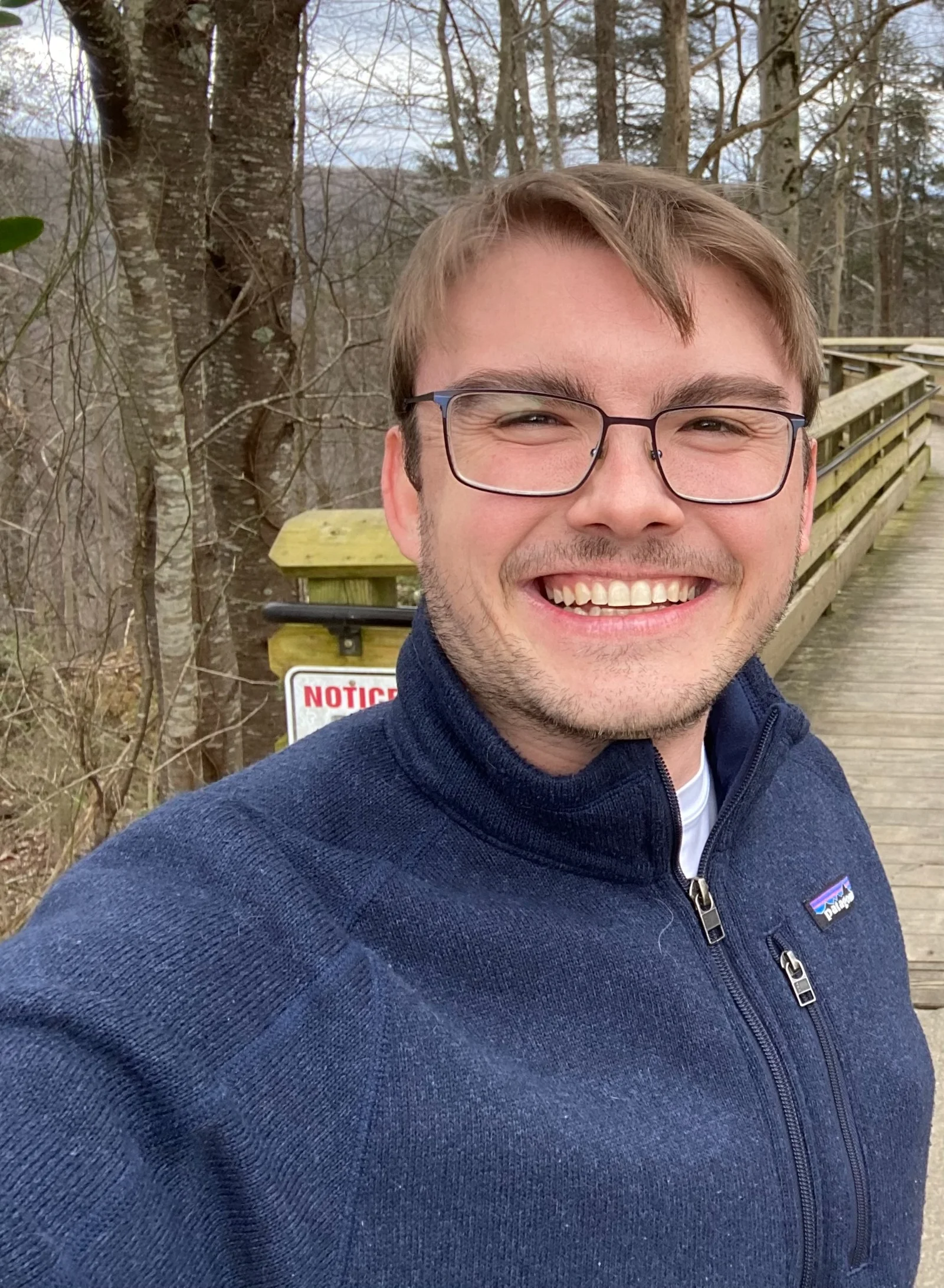 Nicholas Davidson, owner and founder of Boxed2Built furniture assembly service, smiling outdoors in Spring Hill Tennessee